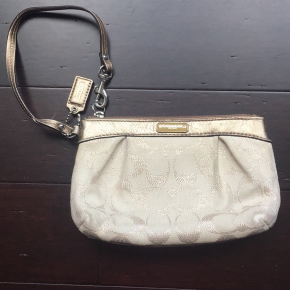 Coach Handbags - Gold monogrammed coach wristlet 7 1/2” x5” x1 1/2”